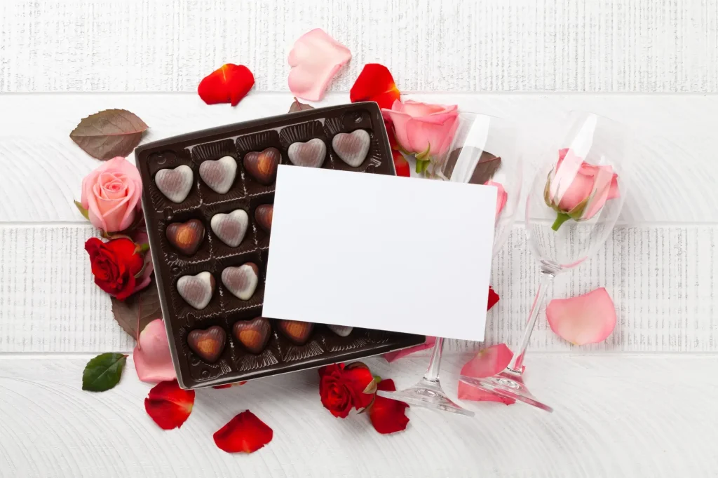 Heart-shaped box of chocolates, roses and champagne flutes for a romantic welcome